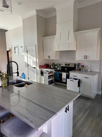 a kitchen with stainless steel appliances granite countertop a stove and a sink
