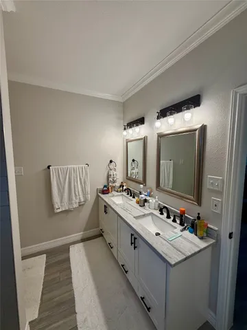 a bathroom with a double vanity sink and mirror