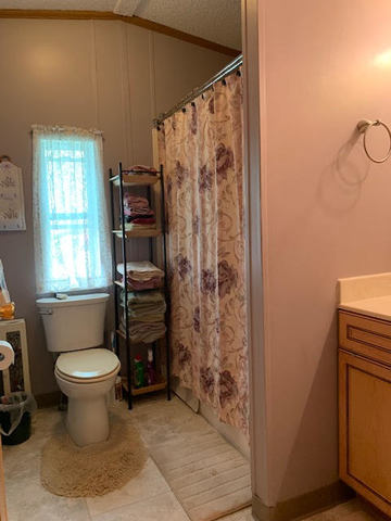 819 South 9th Street DeKalb, IL 60115 - Photo 12 of 20 a bathroom with a toilet and a shower curtain