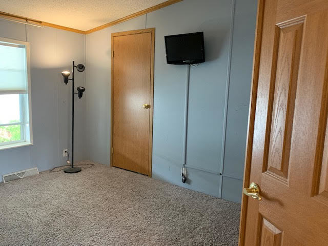 819 South 9th Street DeKalb, IL 60115 - Photo 13 of 20 a view of a livingroom with wooden floor and a flat screen tv