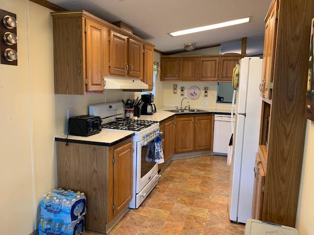 819 South 9th Street DeKalb, IL 60115 - Photo 3 of 20 a kitchen with stainless steel appliances granite countertop a sink stove and refrigerator