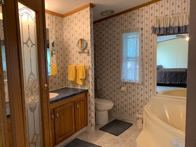 819 South 9th Street DeKalb, IL 60115 - Photo 10 of 20 a bathroom with a sink a toilet and shower
