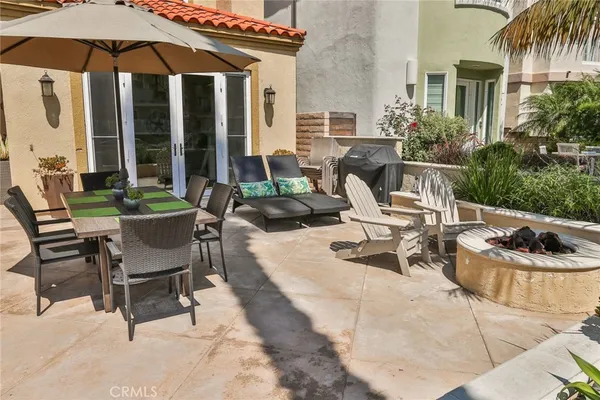 a view of a patio with table and chairs under an umbrella