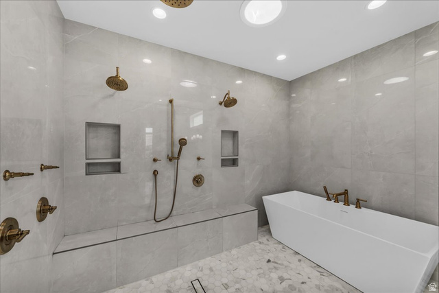2608 Canyon Ridge Drive St. George, UT 84770 - Photo 37 of 86 Spacious wet room featuring a freestanding soaking tub, dual rain shower heads, handheld shower fixture, built-in shower bench, and integrated shower niches