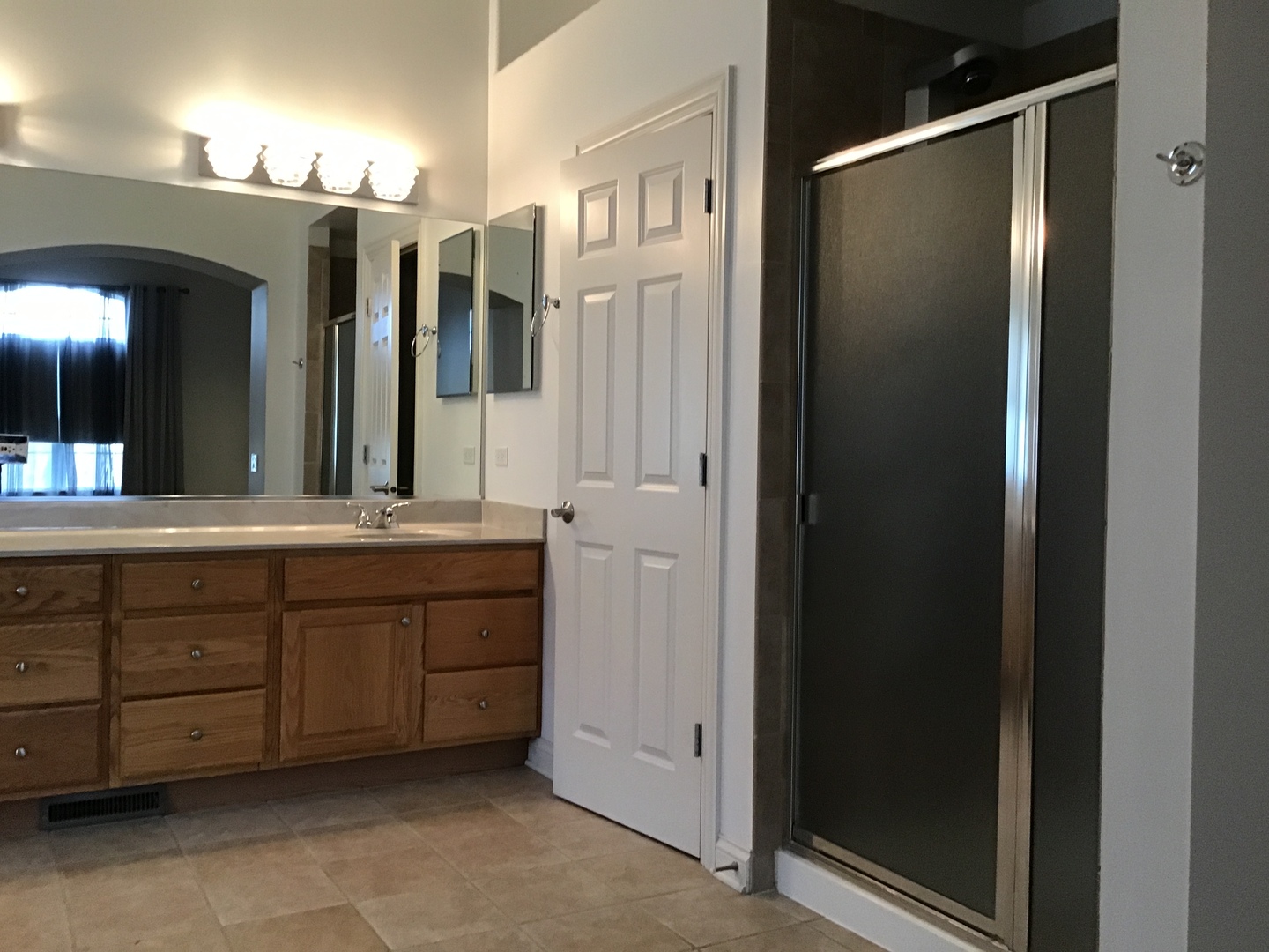 1686 Constitution Drive Glenview, IL 60026 - Photo 13 of 22 a bathroom with a double vanity sink and a mirror