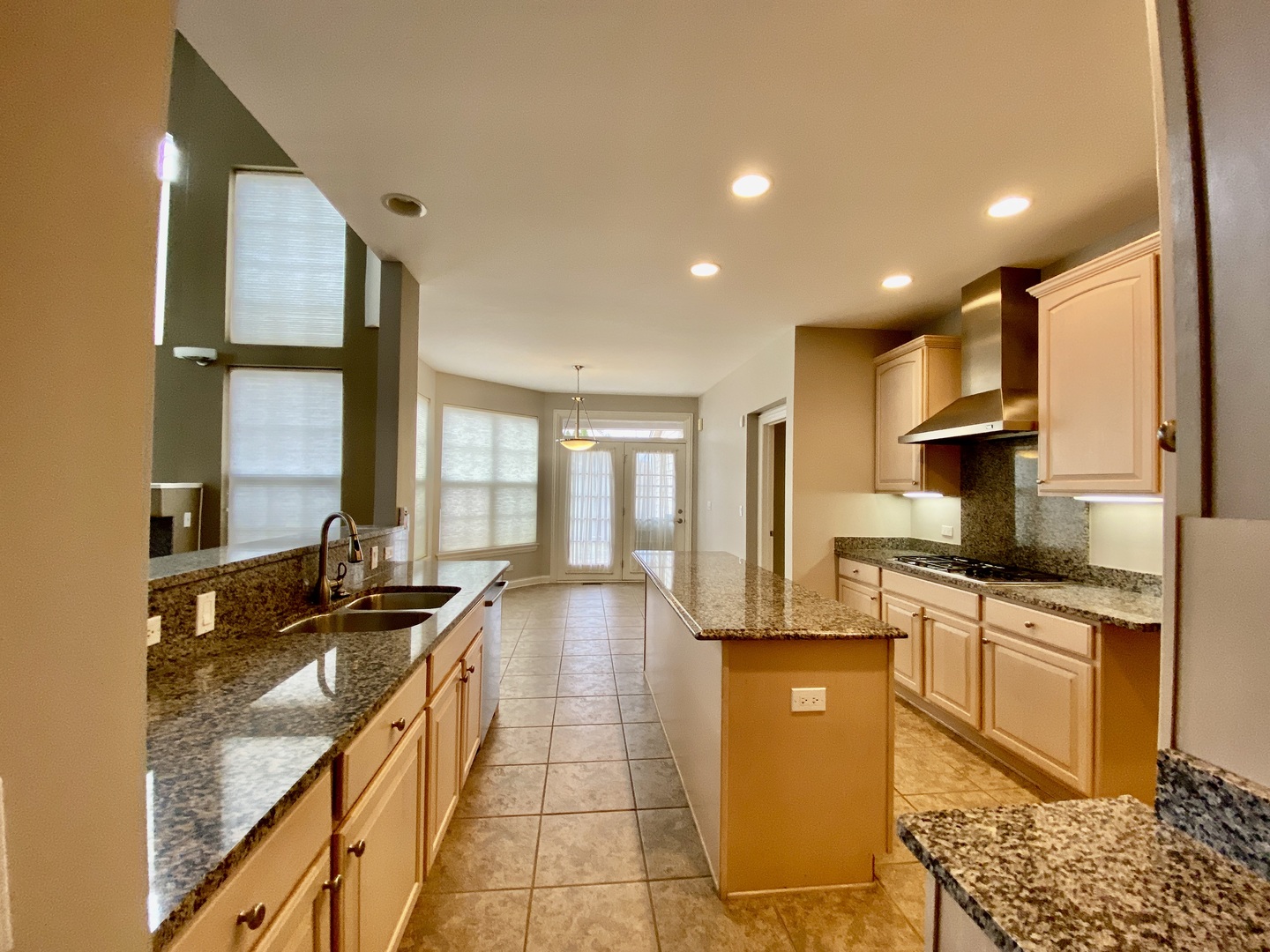 1686 Constitution Drive Glenview, IL 60026 - Photo 5 of 22 a large kitchen with kitchen island granite countertop a large window and a counter space