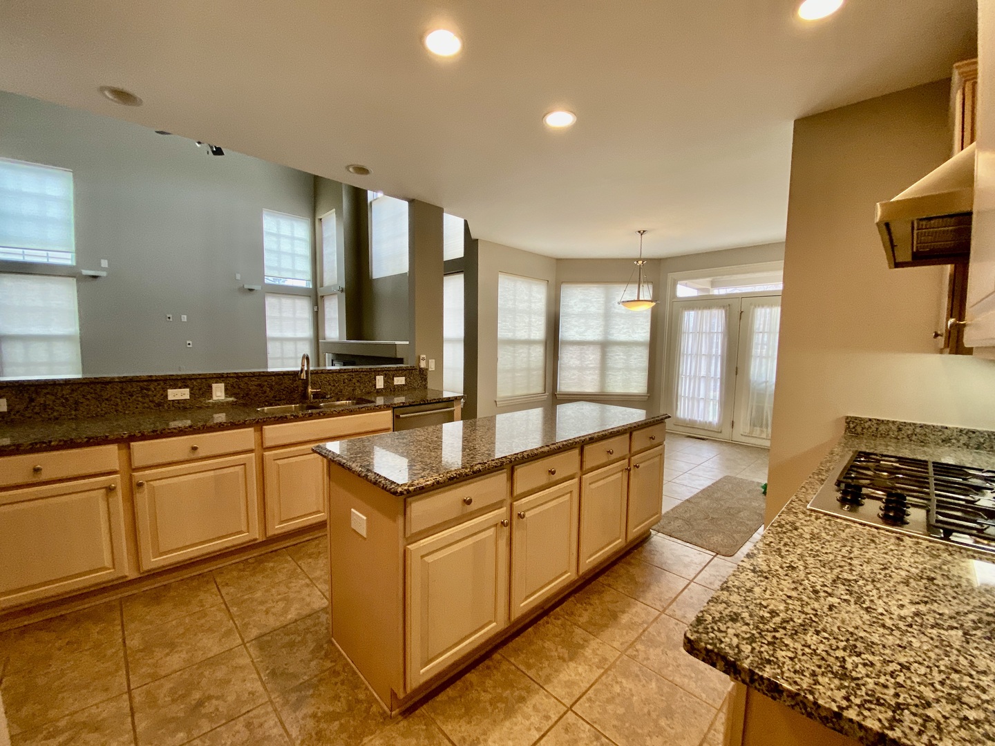1686 Constitution Drive Glenview, IL 60026 - Photo 6 of 22 a large kitchen with kitchen island granite countertop a large window and white cabinets