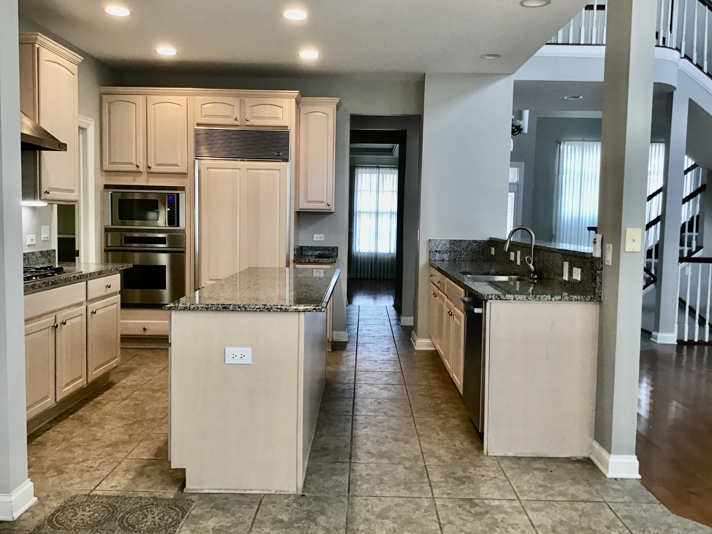 1686 Constitution Drive Glenview, IL 60026 - Photo 9 of 22 a kitchen with stainless steel appliances granite countertop a refrigerator a stove and a sink