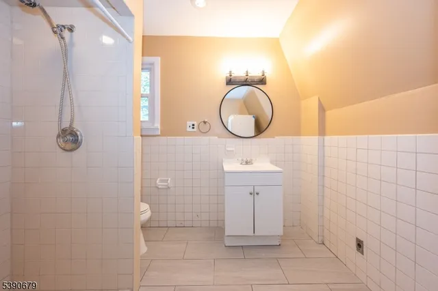 a bathroom with a sink a toilet and a shower