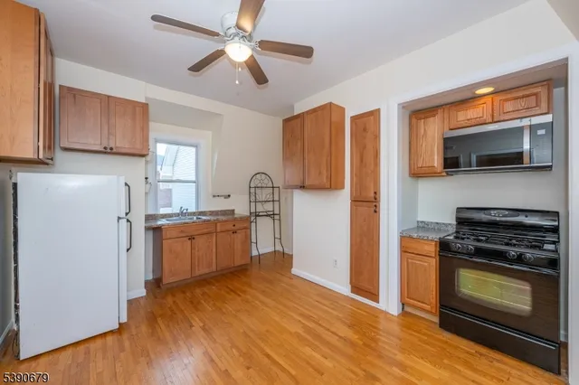 a kitchen with a stove a refrigerator and a microwave