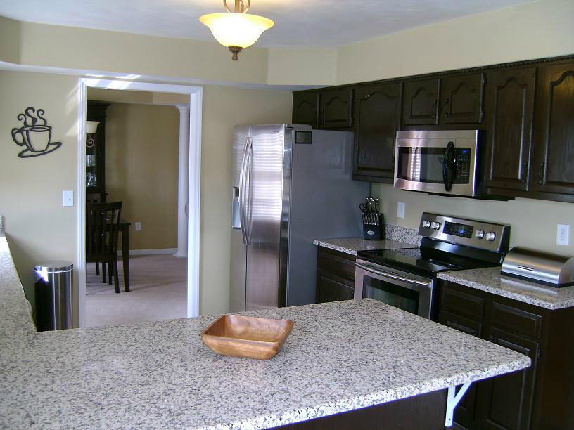 1741 Meadows Road Vinton, VA 24179 - Photo 9 of 23 a kitchen with stainless steel appliances granite countertop a stove refrigerator and cabinets