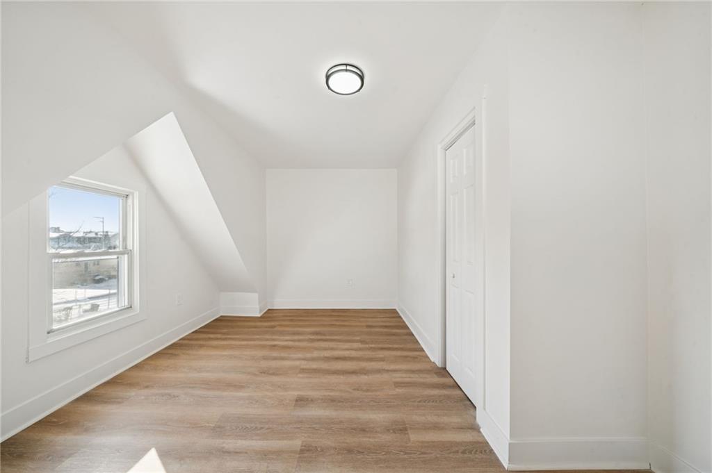216 Whipple Street Pittsburgh, PA 15218 - Photo 20 of 29 a view of an empty room with wooden floor and a window