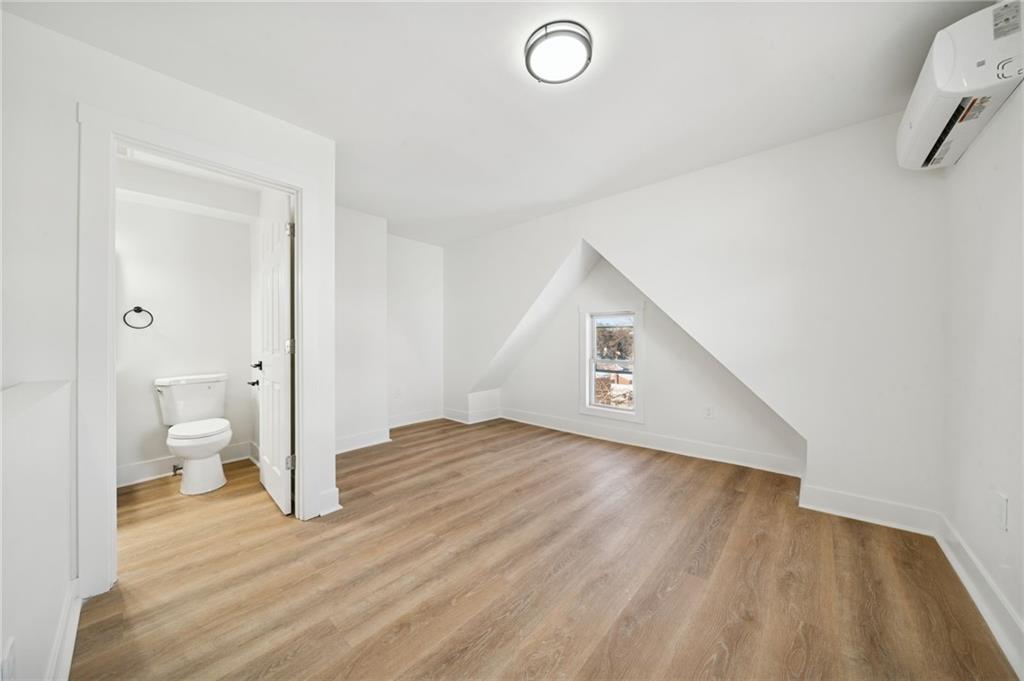 216 Whipple Street Pittsburgh, PA 15218 - Photo 21 of 29 a view of a hallway with wooden floor and a bathroom