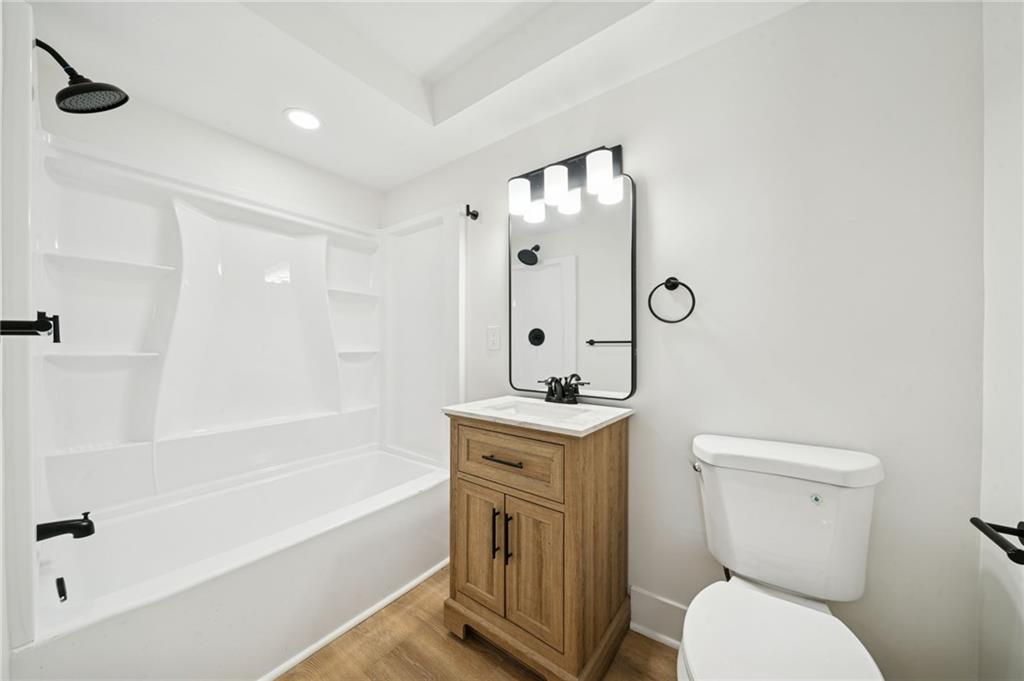 216 Whipple Street Pittsburgh, PA 15218 - Photo 22 of 29 a bathroom with a granite countertop toilet a sink and a bathtub