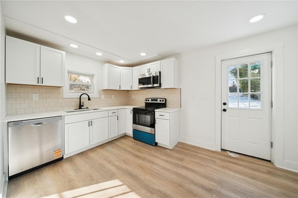 216 Whipple Street Pittsburgh, PA 15218 - Photo 5 of 29 a kitchen with granite countertop white cabinets and white appliances