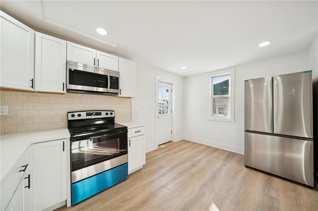 216 Whipple Street Pittsburgh, PA 15218 - Photo 6 of 29 a kitchen with a refrigerator stove and microwave