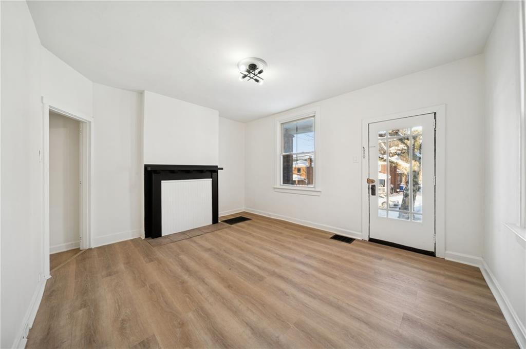 216 Whipple Street Pittsburgh, PA 15218 - Photo 9 of 29 a view of an empty room with window and wooden floor