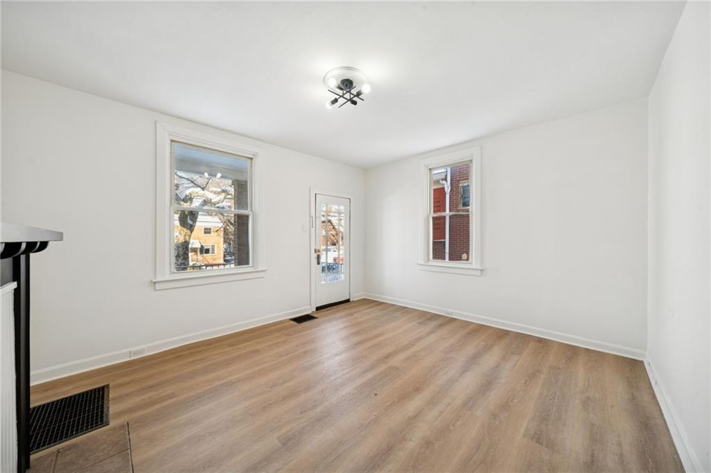 216 Whipple Street Pittsburgh, PA 15218 - Photo 10 of 29 wooden floor in an empty room with a window