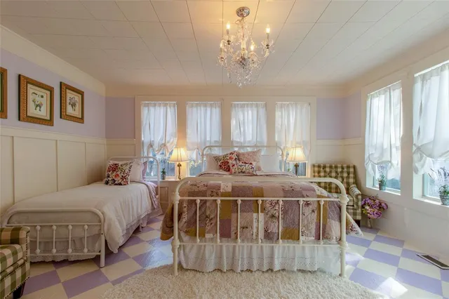 a bedroom with bed and a chandelier