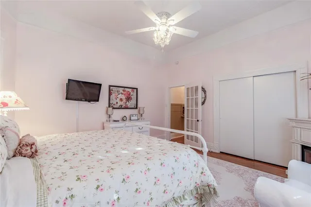 a bedroom with a bed and a chandelier