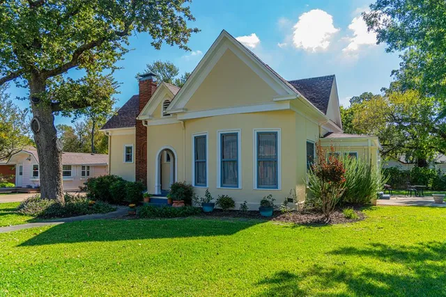 a front view of house with yard and green space