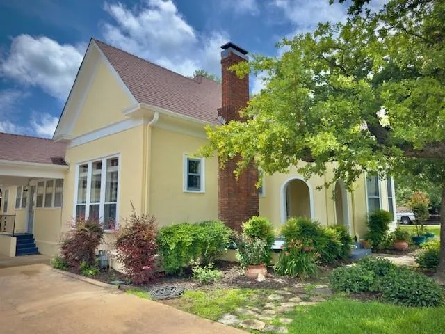 a front view of house with yard and outdoor seating