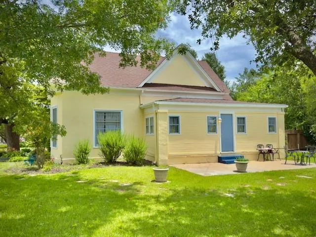 a view of a house with a yard and sitting area