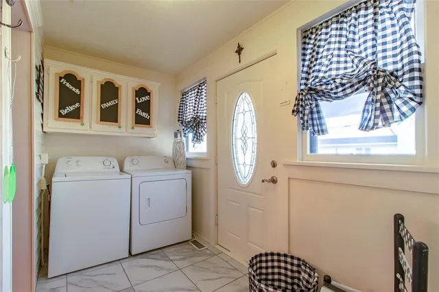 a bedroom with two beds and a chandelier