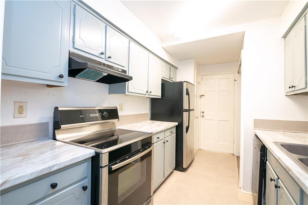 a kitchen with stainless steel appliances granite countertop a stove a refrigerator and a microwave