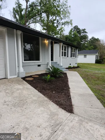 a front view of a house with garden