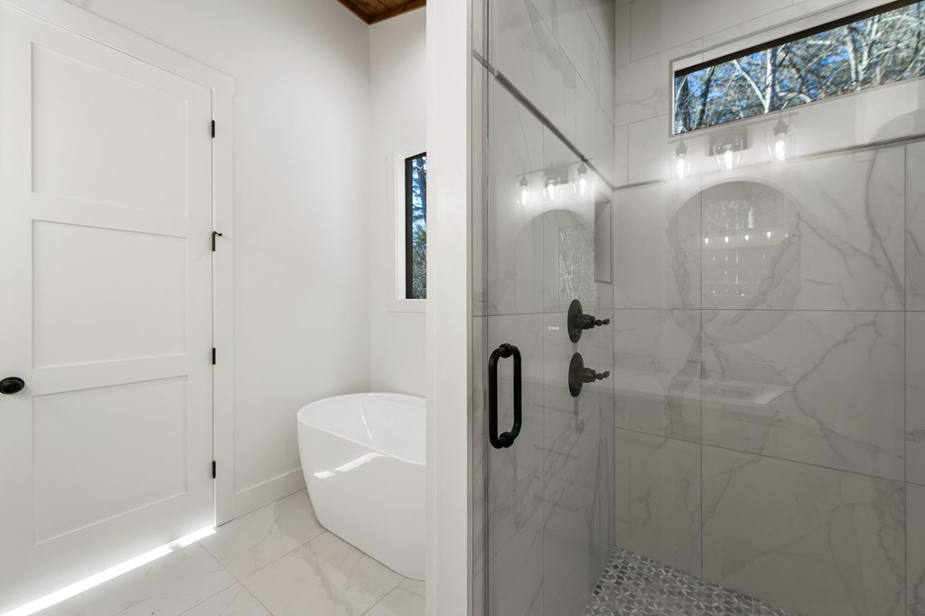 770 Fish Hook Point Blue Ridge, GA 30513 - Photo 49 of 96 Owners Bathroom, Soft Close Cabinetry + LED Touch SMART Mirrors + Quartz Countertops + Tile Floor + Free Standing Tub/Filler + Walk In Shower with Dual Rain Shower Heads + Frameless Shower | Vaulted Stained Ceiling