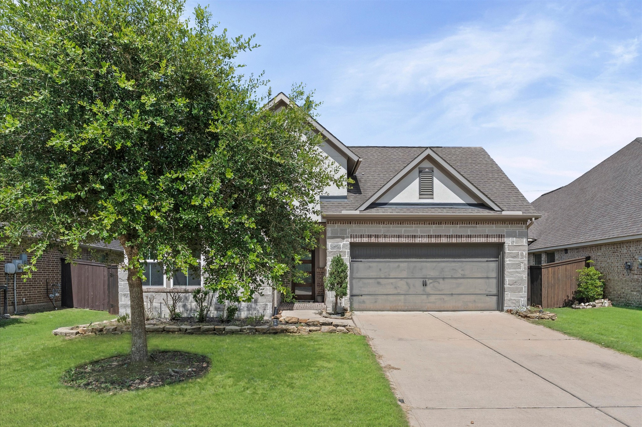3510 Whitman Drive Rosharon, TX 77583 - Photo 1 of 25 This charming home features a stone and brick exterior with a two-car garage and a well-maintained front yard. A mature tree provides shade, enhancing the curb appeal. The property is nestled in a suburban neighborhood, offering a welcoming and attractive facade.