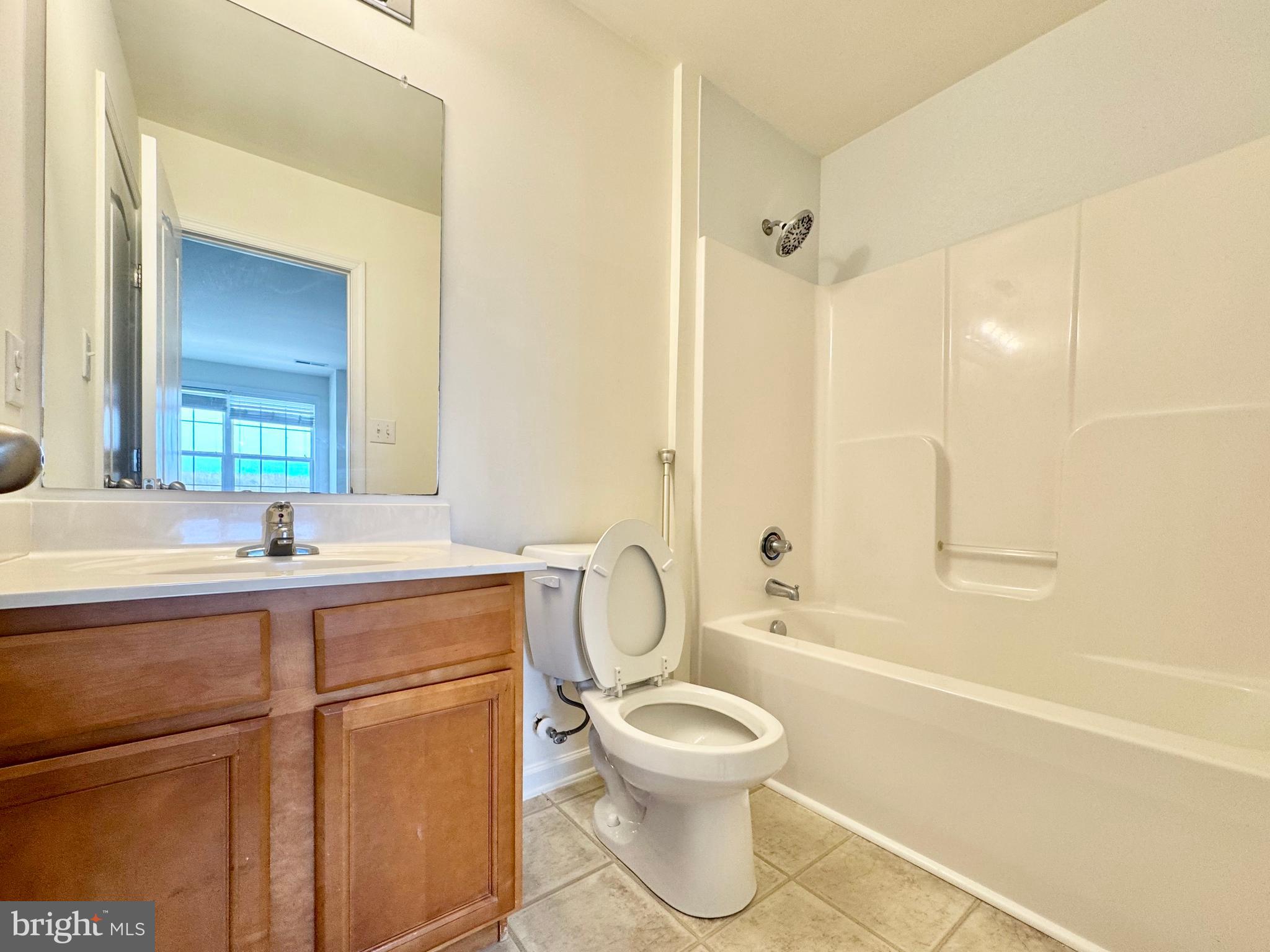 56 Nicholas Drive Dover, DE 19901 - Photo 13 of 23 a bathroom with a toilet sink vanity tub and shower
