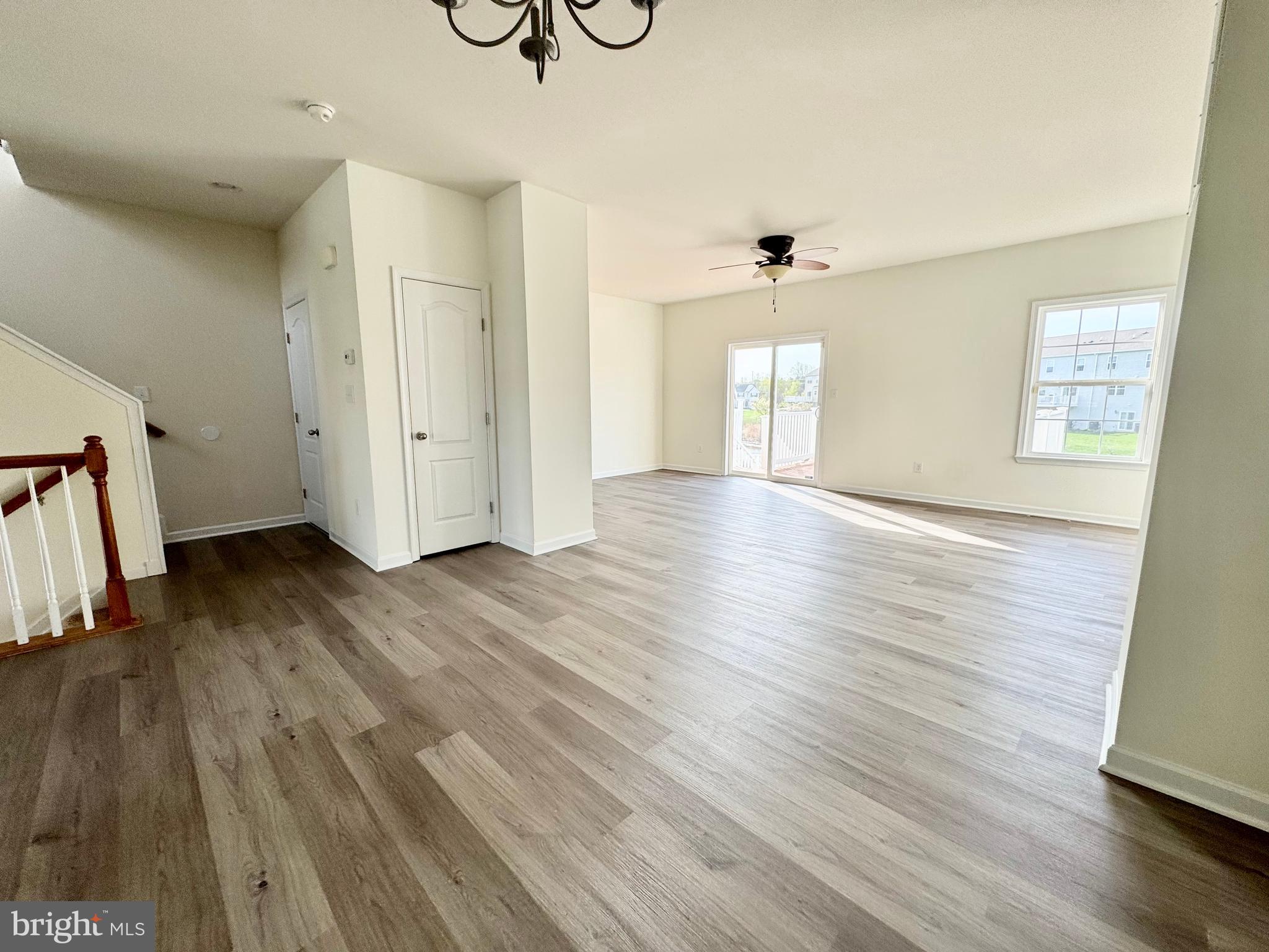 56 Nicholas Drive Dover, DE 19901 - Photo 2 of 23 an empty room with wooden floor and windows