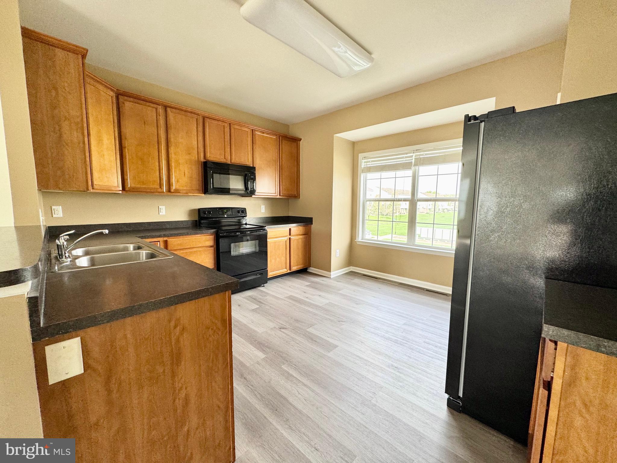 56 Nicholas Drive Dover, DE 19901 - Photo 5 of 23 a kitchen with stainless steel appliances granite countertop a refrigerator a stove top oven a sink and dishwasher