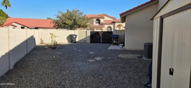 a view of a house with a backyard