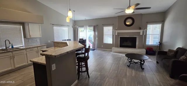 a living room with furniture a fireplace and a large window