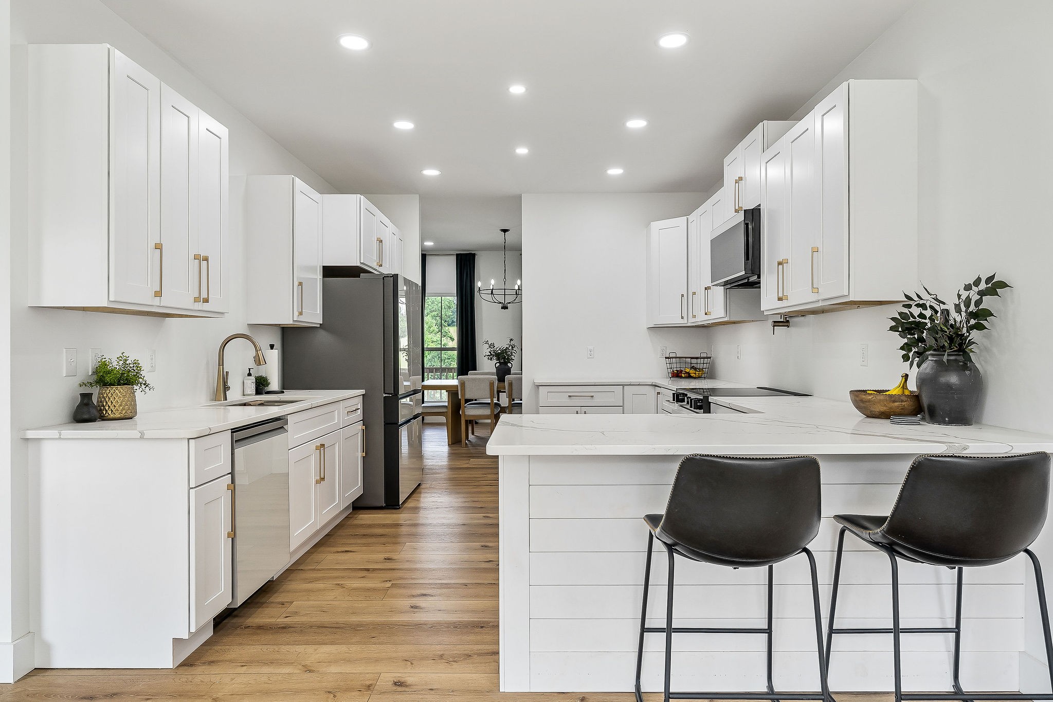 250 Dyer Ridge Road Baxter, TN 38544 - Photo 11 of 45 a kitchen with stainless steel appliances kitchen island granite countertop a stove a sink a refrigerator and white cabinets with wooden floor