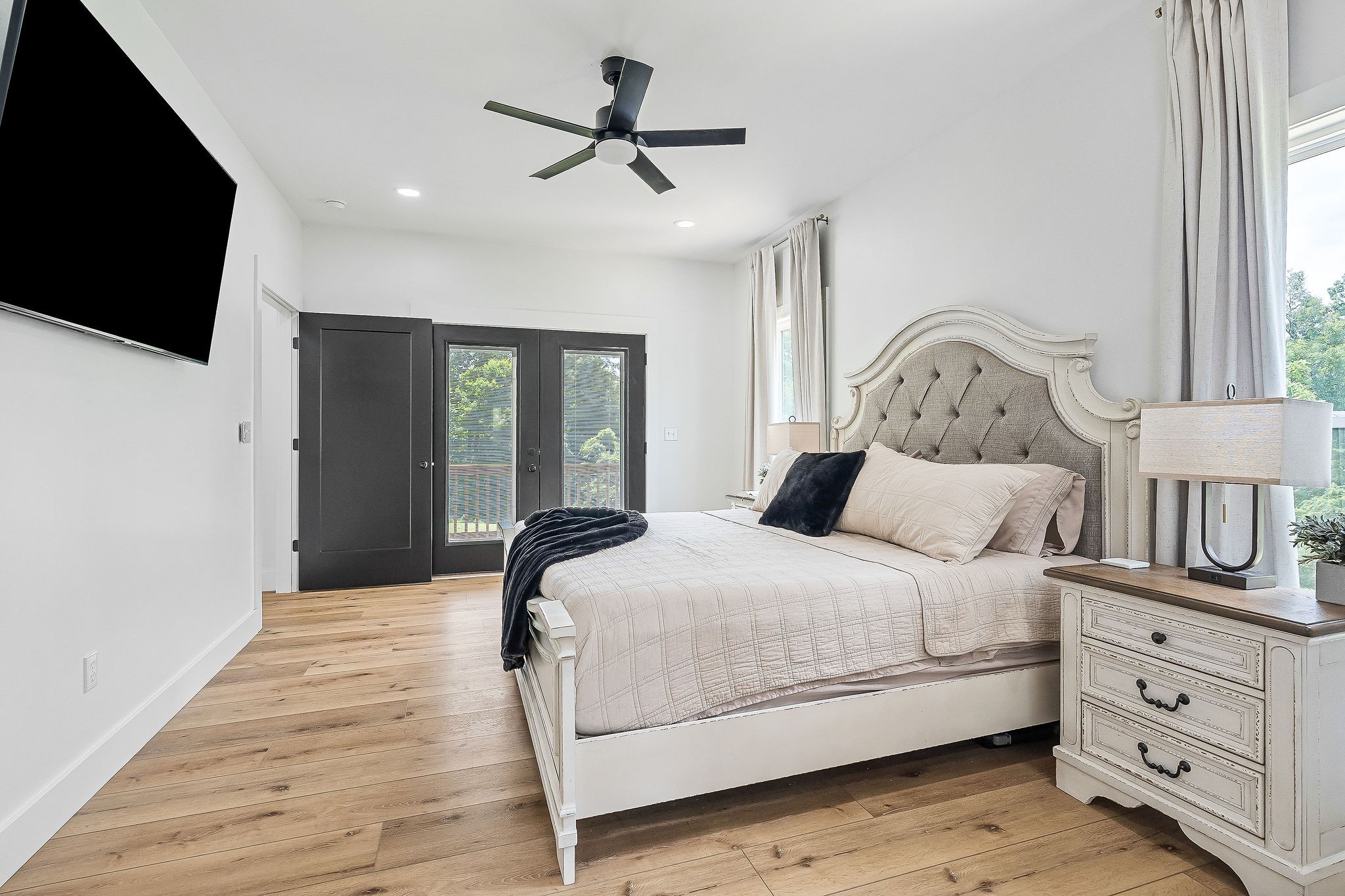 250 Dyer Ridge Road Baxter, TN 38544 - Photo 18 of 44 a bedroom with a bed a window and a flat screen tv