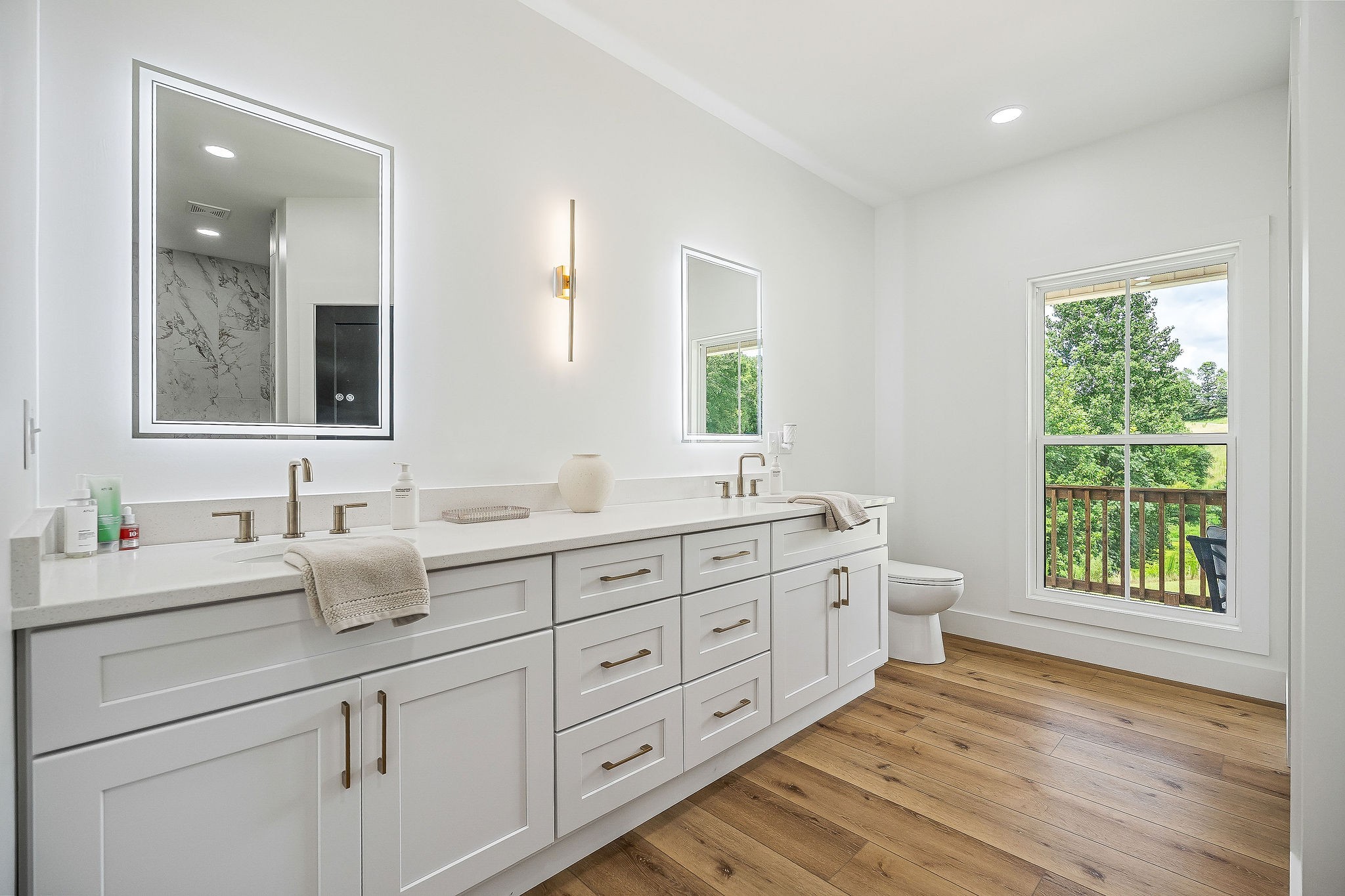 250 Dyer Ridge Road Baxter, TN 38544 - Photo 19 of 44 a bathroom with double vanity sink a two mirror a window and a bathtub