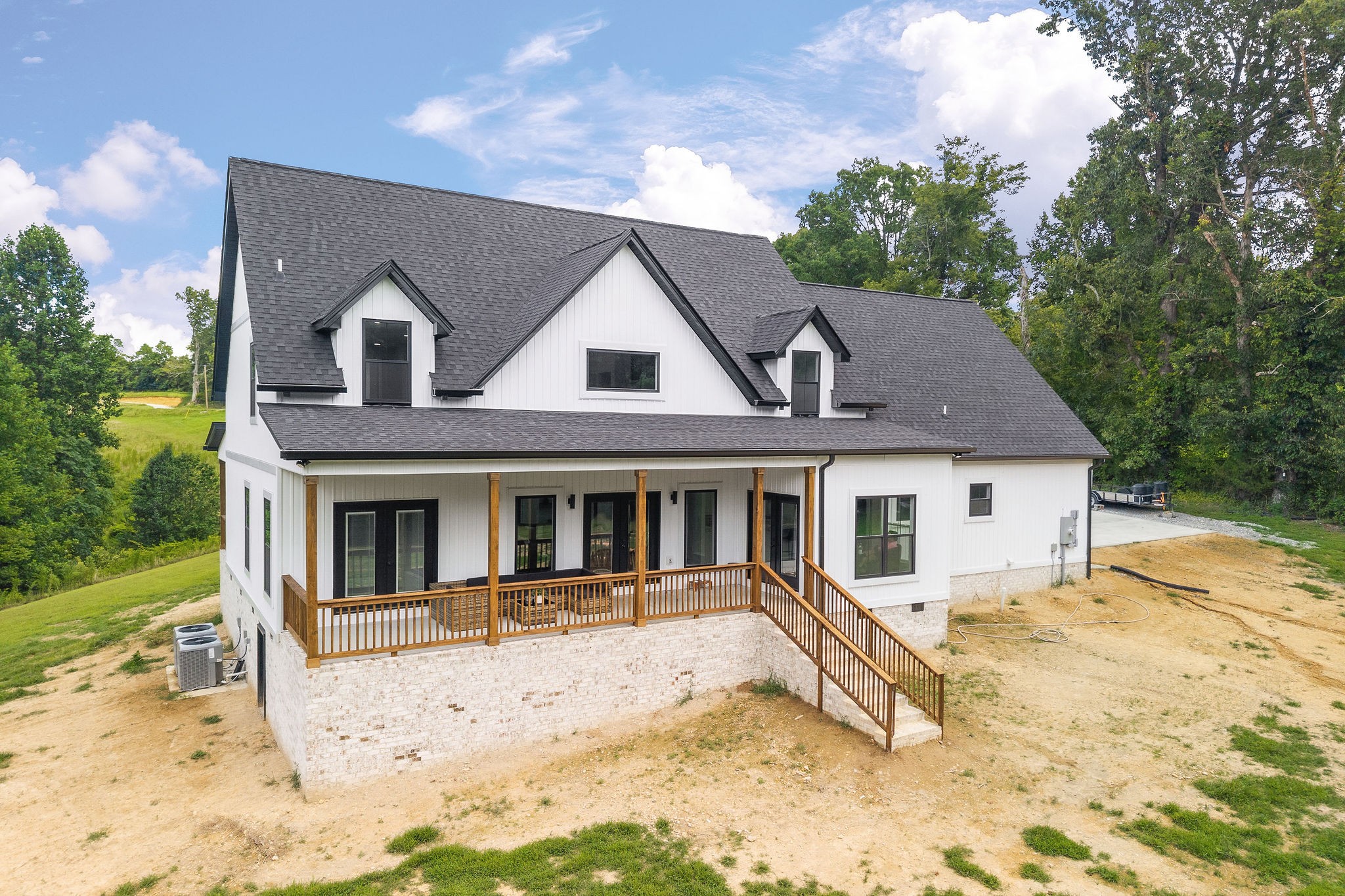 250 Dyer Ridge Road Baxter, TN 38544 - Photo 36 of 44 a view of a white house with large windows and a wooden fence