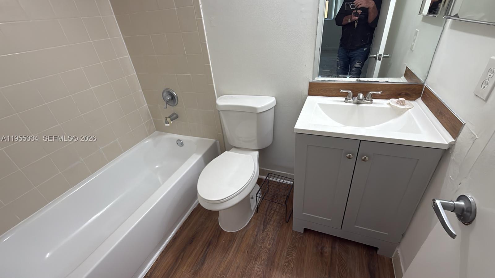 15620 Southwest 80th Street, Unit H203 Miami, FL 33193 - Photo 11 of 11 a bathroom with a sink toilet and shower