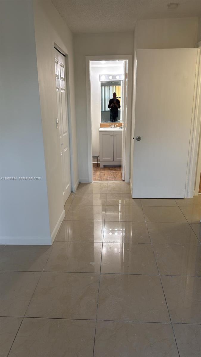 15620 Southwest 80th Street, Unit H203 Miami, FL 33193 - Photo 8 of 11 a view of a hallway with wooden floor and cabinet