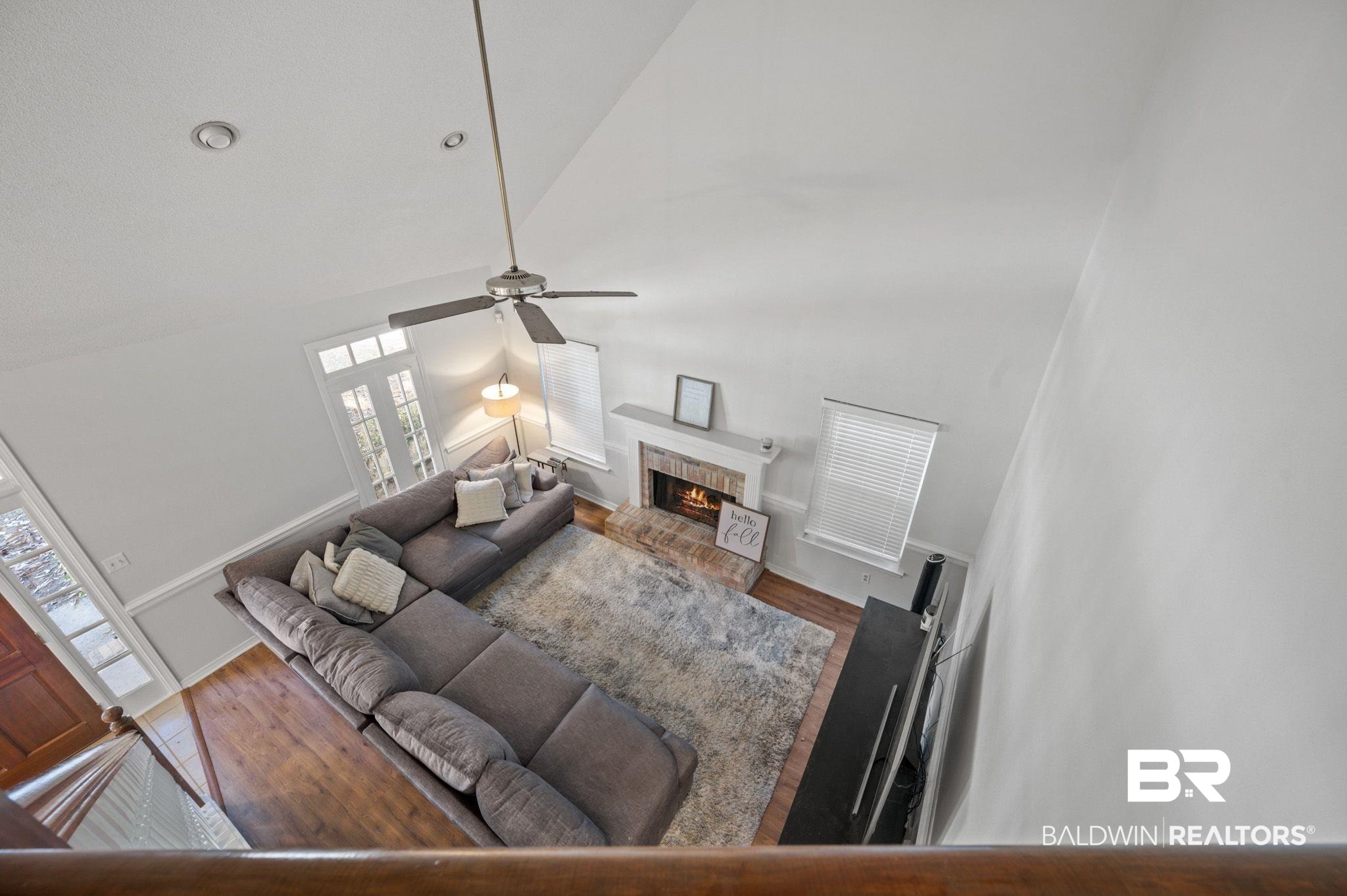 6705 Autumn Ridge Drive Mobile, AL 36695 - Photo 17 of 24 Living room featuring plenty of natural light, high vaulted ceiling, hardwood / wood-style floors, and a brick fireplace