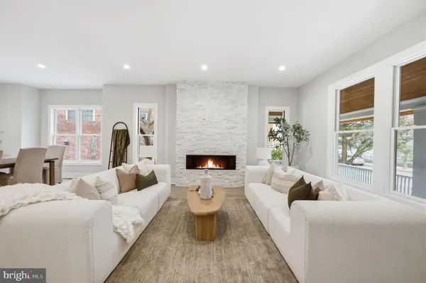 a living room with furniture and a fireplace