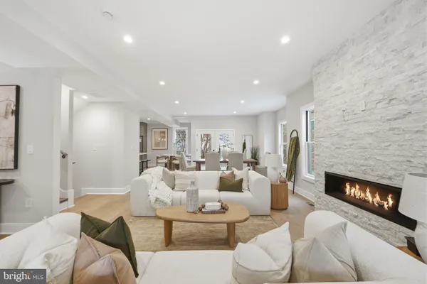a living room with fireplace furniture and a fireplace