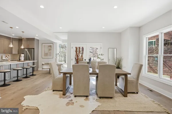 a dining room with furniture and wooden floor