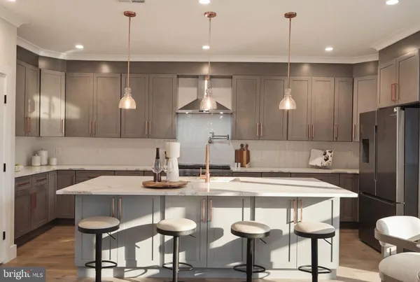 a kitchen with kitchen island granite countertop a sink a counter space and stainless steel appliances