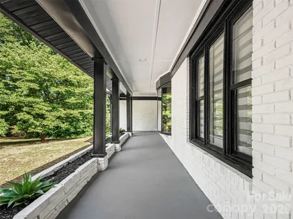 a view of a room with wooden floor and windows