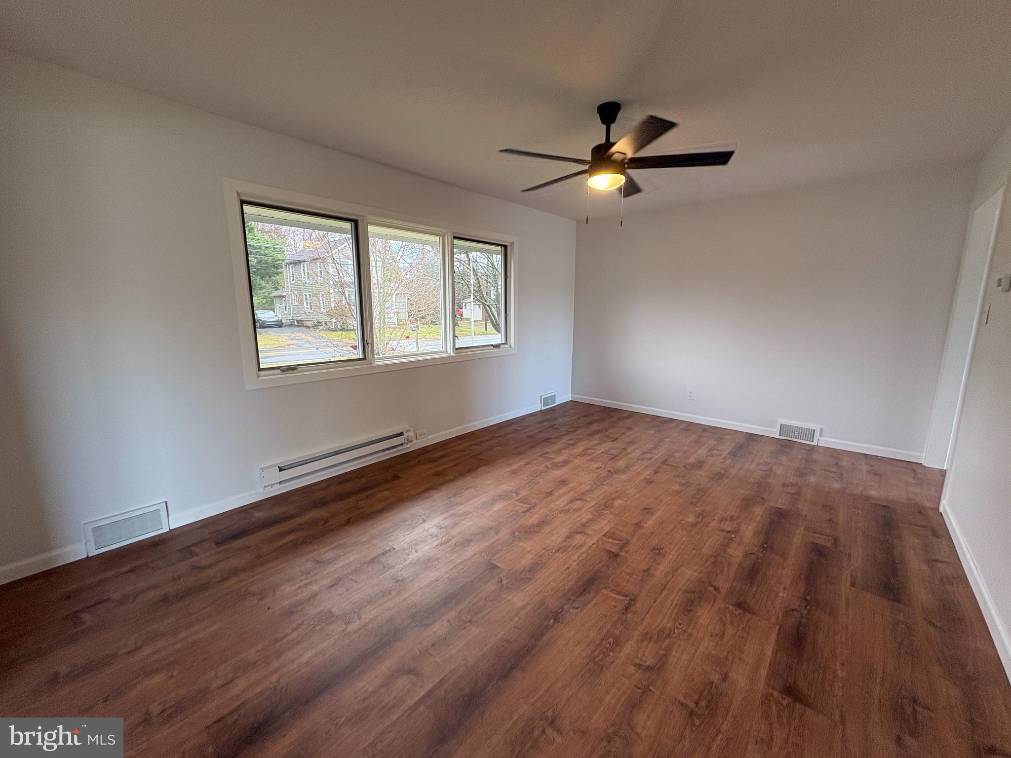 18 Crosswicks Chesterfield Road Crosswicks, NJ 08515 - Photo 4 of 20 a view of empty room with wooden floor and fan